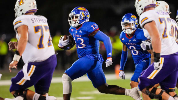 Sep 2, 2022; Lawrence, Kansas, USA; Kansas Jayhawks linebacker Eriq Gilyard (13) returns an interception against the Tennessee Tech Golden Eagles during the second half at David Booth Kansas Memorial Stadium. Mandatory Credit: Jay Biggerstaff-USA TODAY Sports